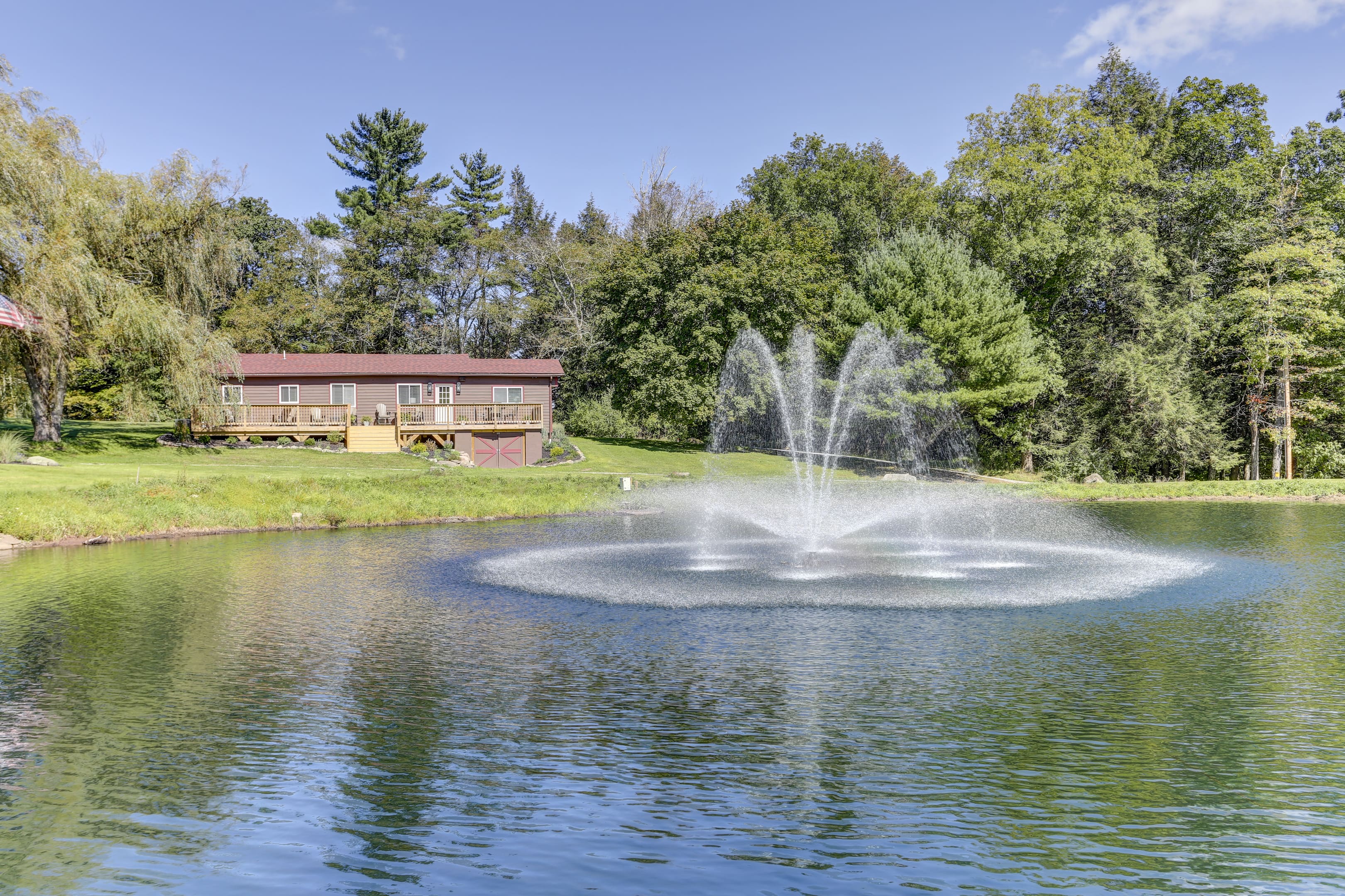 A fountain in the middle of a pond.