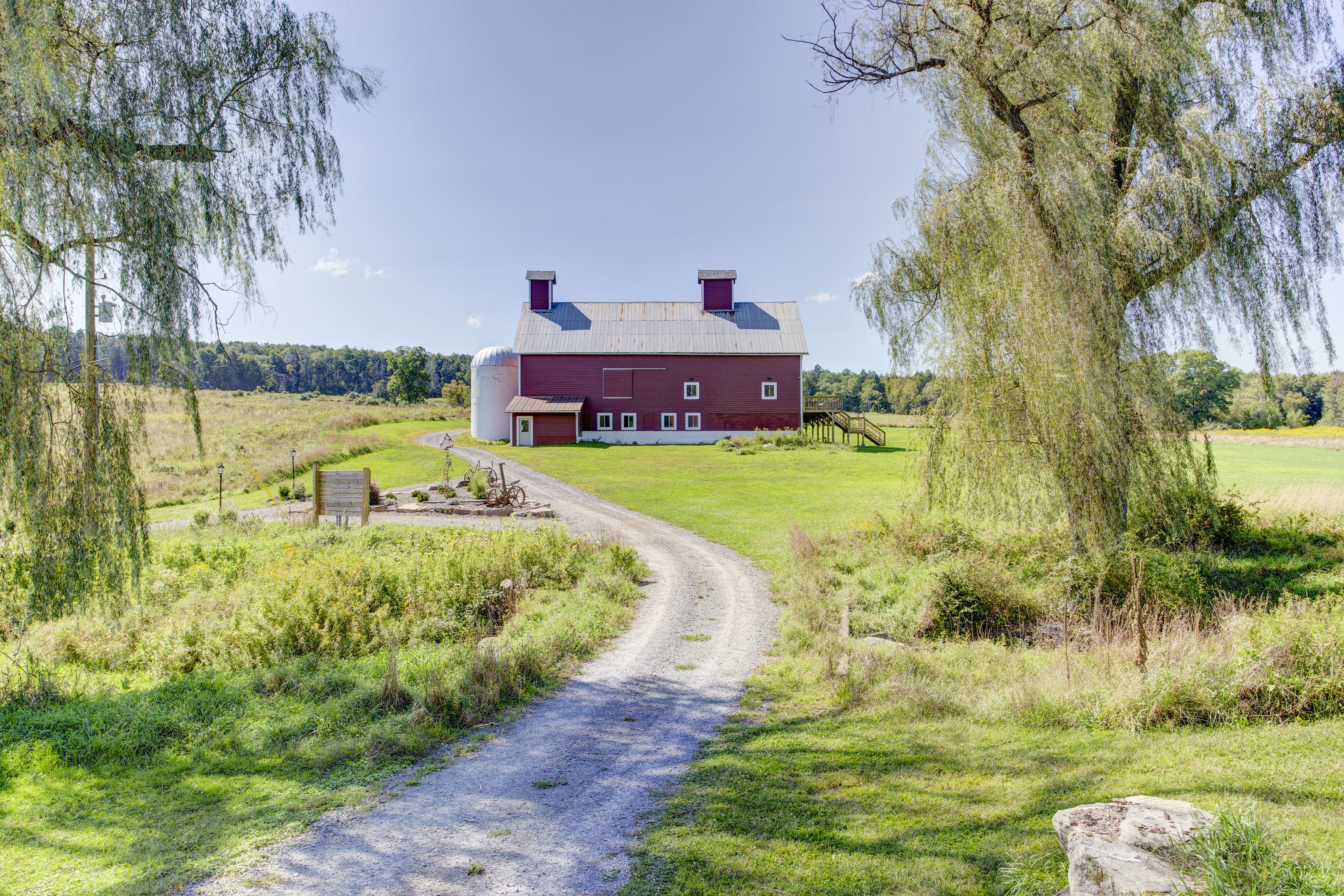 A red barn sitting on top of a green field.