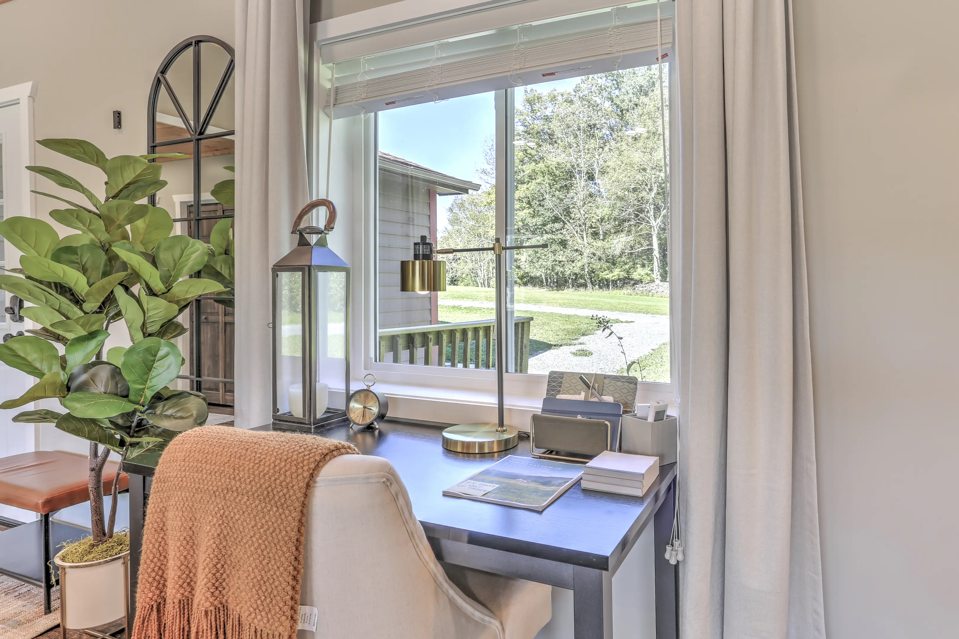 A desk with a lamp and a window