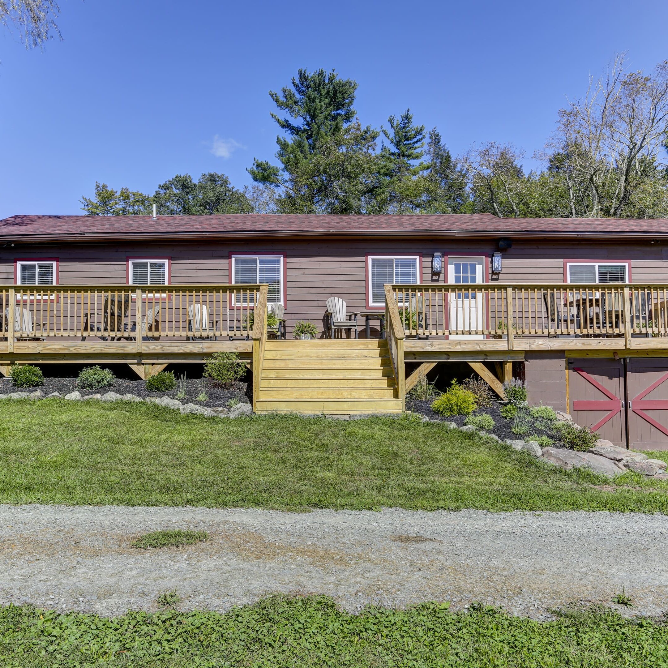 A large wooden deck with steps leading to the front of it.